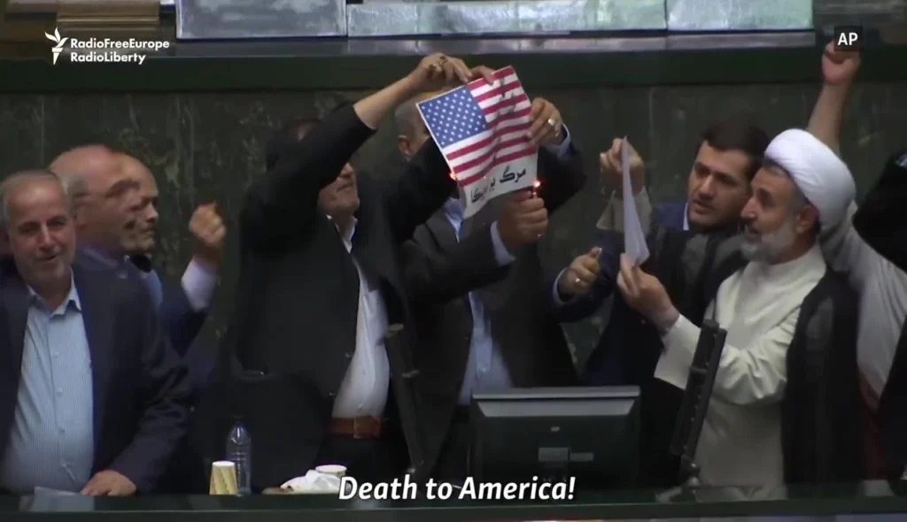 Iranian lawmakers burning a U.S. flag in Parliament