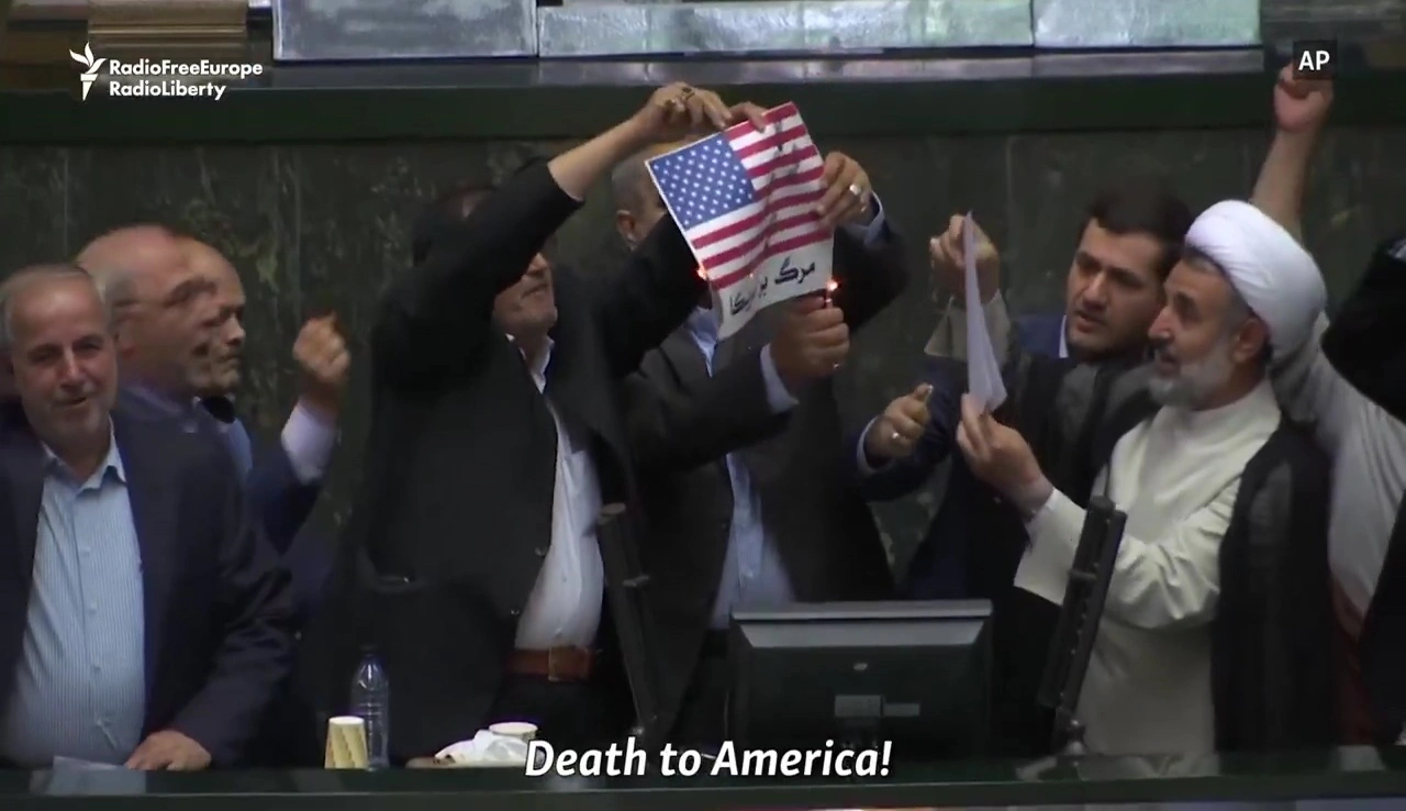 Iranian lawmakers burning a U.S. flag in Parliament